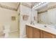 Traditional bathroom features a double sink vanity, neutral color palette, and glass shower at 1799 Fountain View Cir, Venice, FL 34292