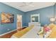 Comfortable bedroom features a white bed frame, wood floors, and stylish decorations at 1799 Fountain View Cir, Venice, FL 34292