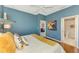 Well-lit bedroom features a white bed frame, wood floors, and stylish decorations at 1799 Fountain View Cir, Venice, FL 34292