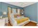 Comfortable bedroom featuring a bay window, soft lighting, and hardwood flooring at 1799 Fountain View Cir, Venice, FL 34292