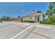 Community clubhouse featuring a well-maintained exterior, landscaping, and convenient parking at 1799 Fountain View Cir, Venice, FL 34292