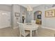 Bright dining area featuring a white table and chairs with hardwood floors at 1799 Fountain View Cir, Venice, FL 34292