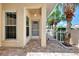 Covered entrance featuring brick pavers, columns, and a view of the front yard at 1799 Fountain View Cir, Venice, FL 34292