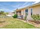 Exterior view showcasing a lovely home with an enclosed porch and lush greenery at 1799 Fountain View Cir, Venice, FL 34292