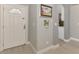 Foyer featuring wood floors, a white front door, and access to the kitchen at 1799 Fountain View Cir, Venice, FL 34292