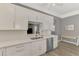 Bright kitchen featuring stainless steel appliances, white cabinetry, quartz countertop and eat-in space at 1799 Fountain View Cir, Venice, FL 34292