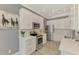 Contemporary kitchen with stainless steel appliances, white cabinets, light counter tops, and hardwood floors at 1799 Fountain View Cir, Venice, FL 34292
