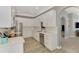 Contemporary kitchen with stainless steel appliances, white cabinets, light countertops and hardwood floors at 1799 Fountain View Cir, Venice, FL 34292