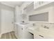 Functional laundry room with modern washer and dryer, white cabinets, and sink at 1799 Fountain View Cir, Venice, FL 34292