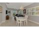 Bright living room featuring a chandelier, neutral walls, plantation shutters, and hardwood floors at 1799 Fountain View Cir, Venice, FL 34292