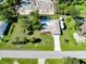 Aerial view of a property with a screened-in pool, RV parking, and well-manicured landscaping at 18375 Lamont Ave, Port Charlotte, FL 33948