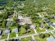 Aerial view of residential area with multiple houses and green space, with a construction site in view at 18375 Lamont Ave, Port Charlotte, FL 33948
