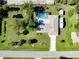 Aerial view of property with a screened-in pool, RV parking, and lush green landscaping at 18375 Lamont Ave, Port Charlotte, FL 33948