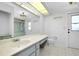 Well-lit bathroom featuring a sleek vanity and countertop, toilet, and glass shower doors at 18375 Lamont Ave, Port Charlotte, FL 33948