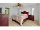 Relaxing bedroom featuring wood floor, ceiling fan, and a comfy bed at 18375 Lamont Ave, Port Charlotte, FL 33948