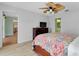 Comfortable bedroom featuring ceiling fan and an adjacent bath at 18375 Lamont Ave, Port Charlotte, FL 33948