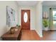 Inviting entryway with wood floors, decorative front door, and stylish decor at 18375 Lamont Ave, Port Charlotte, FL 33948
