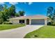 Well-maintained single-story home with a manicured lawn and attached two-car garage at 18375 Lamont Ave, Port Charlotte, FL 33948