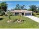Charming single-story home boasts a manicured lawn and an inviting facade at 18375 Lamont Ave, Port Charlotte, FL 33948