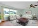 Bright living room featuring large windows and comfortable, neutral-toned furnishings at 18375 Lamont Ave, Port Charlotte, FL 33948