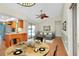 Open-concept living area with a dining table, kitchen access, and sliding door to the backyard pool at 18375 Lamont Ave, Port Charlotte, FL 33948