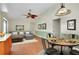 Bright living area connects dining and kitchen with a modern sofa and an eye-catching fan at 18375 Lamont Ave, Port Charlotte, FL 33948