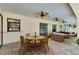 Outdoor dining and lounge area under covered patio featuring ceiling fans, dining table and sofa seating at 18375 Lamont Ave, Port Charlotte, FL 33948