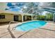 Backyard pool with screened enclosure and brick paver patio, perfect for outdoor enjoyment at 18375 Lamont Ave, Port Charlotte, FL 33948