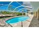 Backyard pool surrounded by a screened enclosure at 18375 Lamont Ave, Port Charlotte, FL 33948