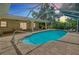 Covered pool area featuring an inground pool and lounge seating at 18375 Lamont Ave, Port Charlotte, FL 33948