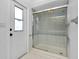 Shower with sliding glass doors, tiled walls and flooring, and door to exterior at 18375 Lamont Ave, Port Charlotte, FL 33948