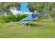 Yard with solar panels against a backdrop of trees and blue sky at 18375 Lamont Ave, Port Charlotte, FL 33948