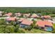 An aerial view showcasing the neighborhood's tile roofs, landscaping, and private screened-in swimming pools at 186 Portofino Dr, Nokomis, FL 34275