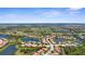 An aerial view displays the community's layout, including lakes, golf course, and tile-roofed homes at 186 Portofino Dr, Nokomis, FL 34275