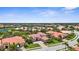 Aerial view of a luxury homes community with a lake and lush landscaping, showcasing the tranquil setting at 186 Portofino Dr, Nokomis, FL 34275