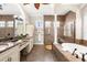 Luxurious bathroom featuring a soaking tub, walk-in shower, dual vanities, and elegant tile work at 186 Portofino Dr, Nokomis, FL 34275