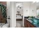 Inviting bathroom featuring a glass-enclosed shower, decorative shower curtain, and view into the bedroom at 186 Portofino Dr, Nokomis, FL 34275