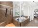 Beautiful bathroom with a glass-enclosed shower, soaking tub, and stylish tile accents at 186 Portofino Dr, Nokomis, FL 34275