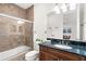 Bathroom with granite countertop, glass shower, and tiled walls at 186 Portofino Dr, Nokomis, FL 34275