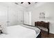 Bright bedroom with hardwood floors, a comfortable bed, and plenty of closet space at 186 Portofino Dr, Nokomis, FL 34275