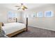 Bright bedroom featuring a ceiling fan, plantation shutters, and neutral carpeting at 186 Portofino Dr, Nokomis, FL 34275