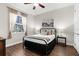 Cozy bedroom featuring hardwood floors, a comfortable bed, and ample natural light at 186 Portofino Dr, Nokomis, FL 34275