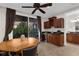 The dining area features dark wood accents, wine storage, and sliding glass doors to the outdoor space at 186 Portofino Dr, Nokomis, FL 34275