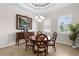 Formal dining room features a chandelier, large windows with blinds, and an accent painting at 186 Portofino Dr, Nokomis, FL 34275