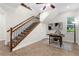 Inviting entryway featuring a staircase with wrought iron railings, neutral tile flooring, and a built-in desk area at 186 Portofino Dr, Nokomis, FL 34275