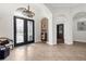 Elegant foyer with double doors, chandelier, tiled floor, and architectural details leading to other rooms at 186 Portofino Dr, Nokomis, FL 34275