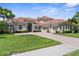 Beautiful home featuring a well-kept lawn, symmetrical landscaping, and a three-car garage for ample parking at 186 Portofino Dr, Nokomis, FL 34275