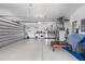 Spacious three car garage with white walls and epoxy flooring for secure parking and extra storage at 186 Portofino Dr, Nokomis, FL 34275