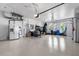 Large three car garage with white walls and floor offering ample space for vehicles and storage at 186 Portofino Dr, Nokomis, FL 34275