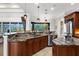 Spacious kitchen featuring custom cabinets, stone countertops, stainless steel appliances, and outdoor views at 186 Portofino Dr, Nokomis, FL 34275